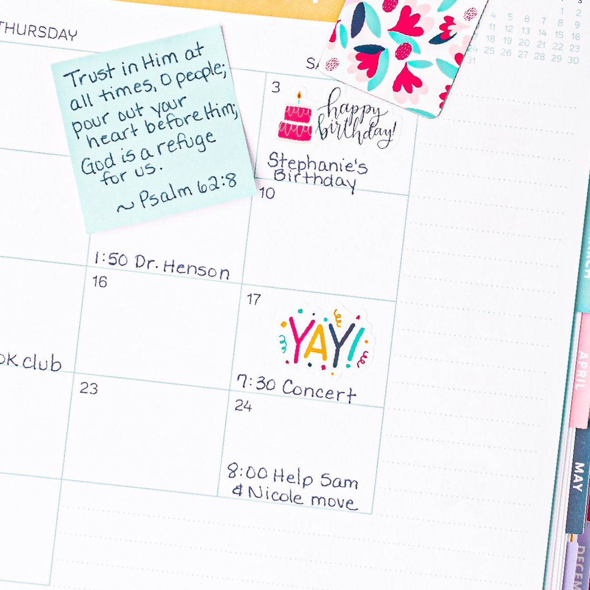 A mockup of a planner open with a sticker that says 'YAY!' with confetti.