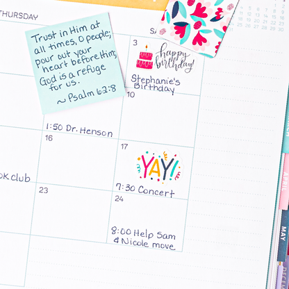 A mockup of a planner open with a sticker that says 'YAY!' with confetti.