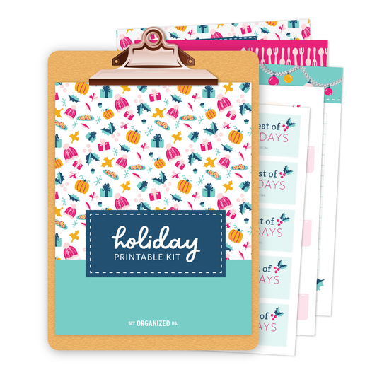 A colorful Holiday Printable Kit on a clipboard, featuring a pattern of holiday icons on the front.