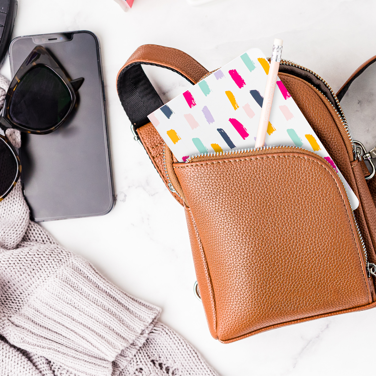 Brown leather purse with a mini notebook in a pocket 