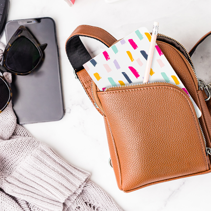 Brown leather purse with a mini notebook in a pocket 