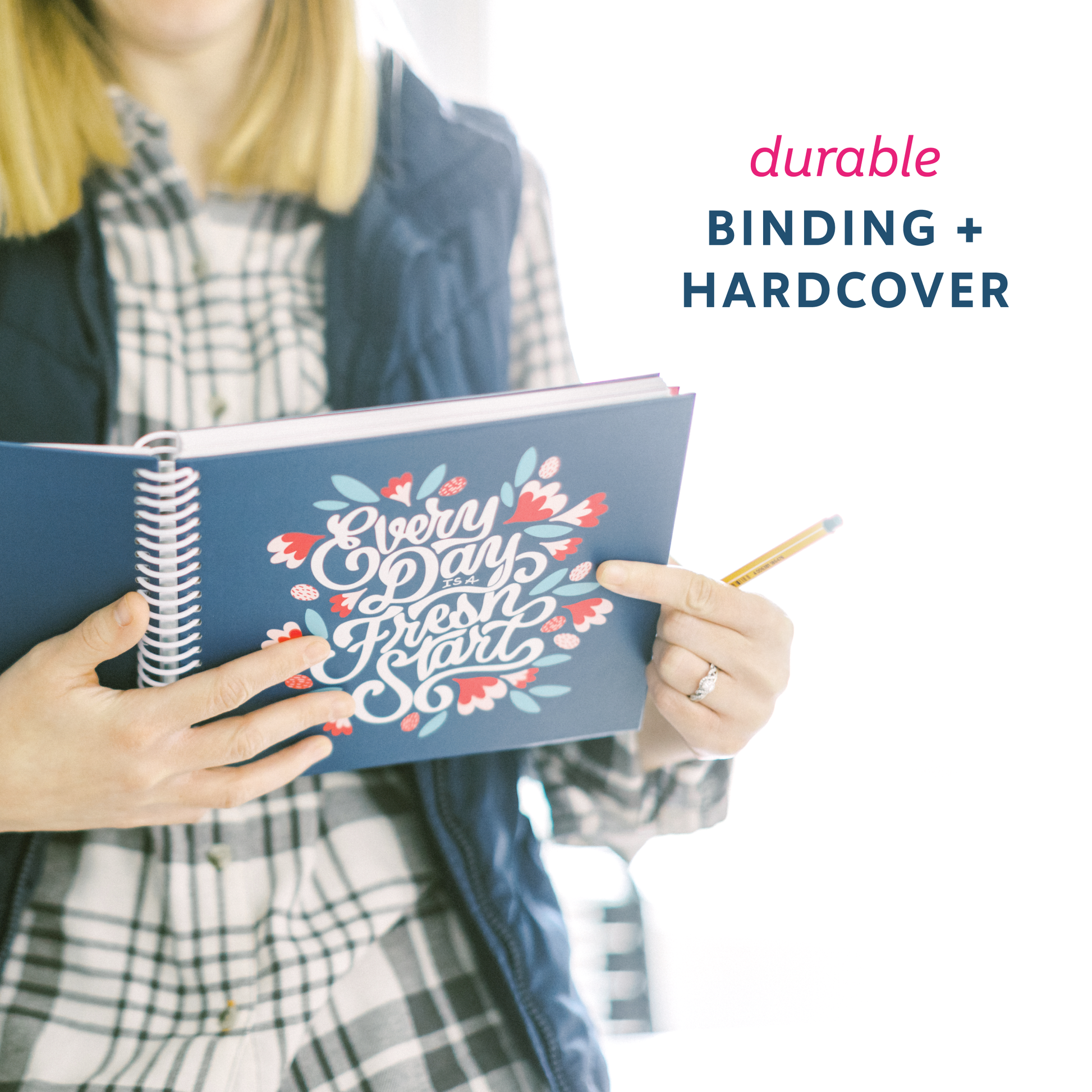 Person holding the navy planner, showcasing the durable binding and hardcover