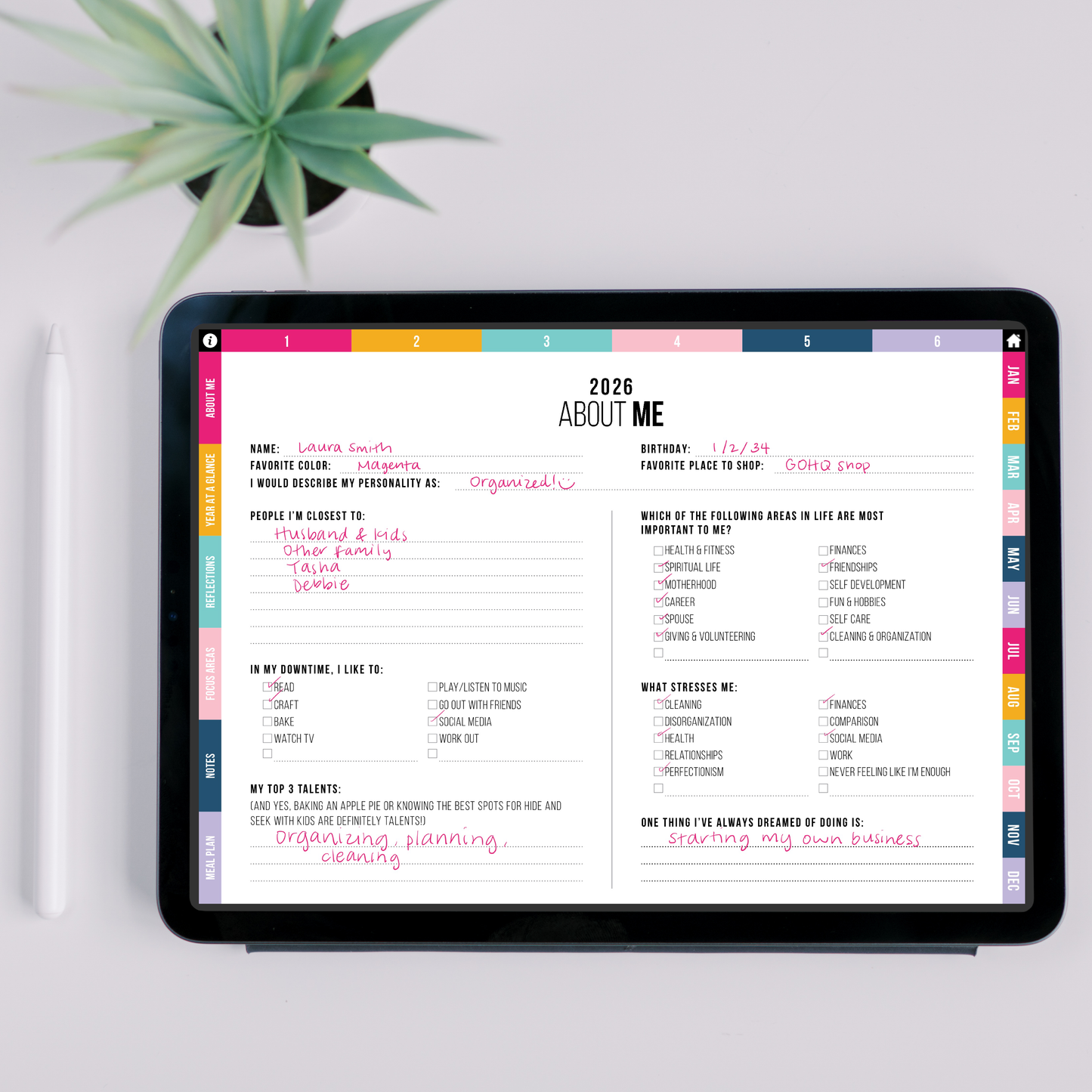 Digital planner on a tablet with 'About Me' section displayed, placed on a white surface with a plant in the background.